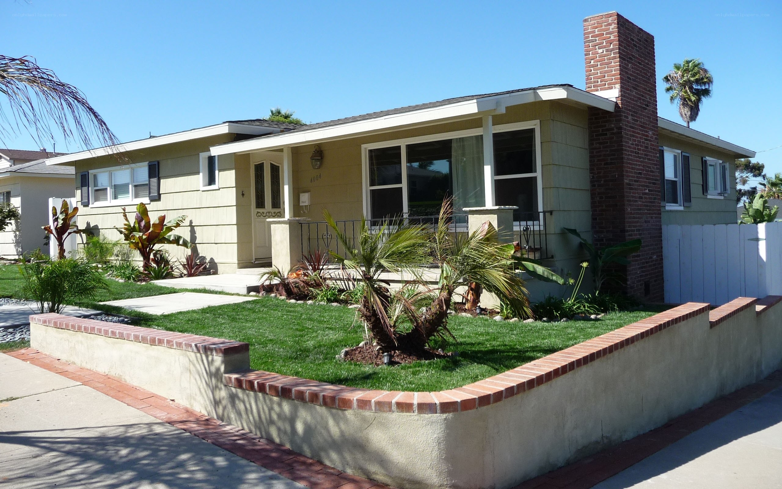 Single-story house with palm trees