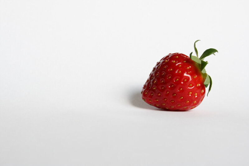 single strawberry on white background