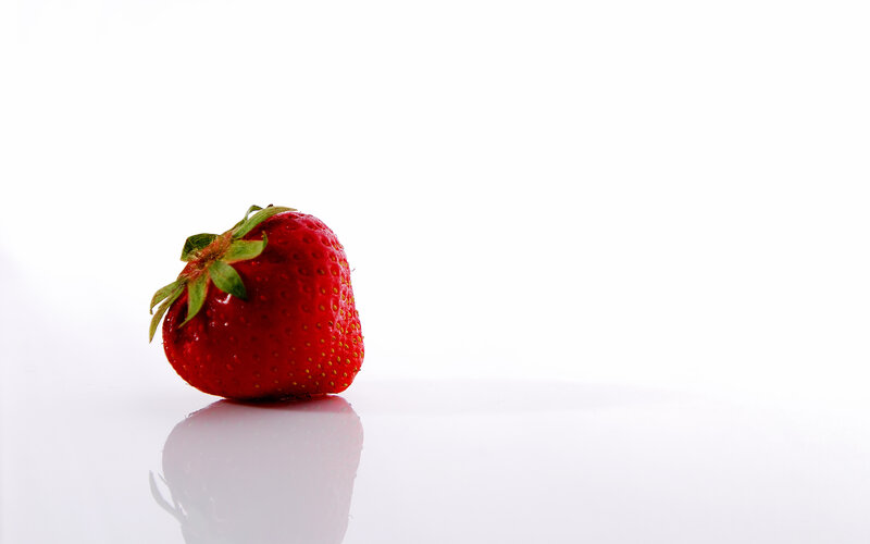 Single strawberry on white background