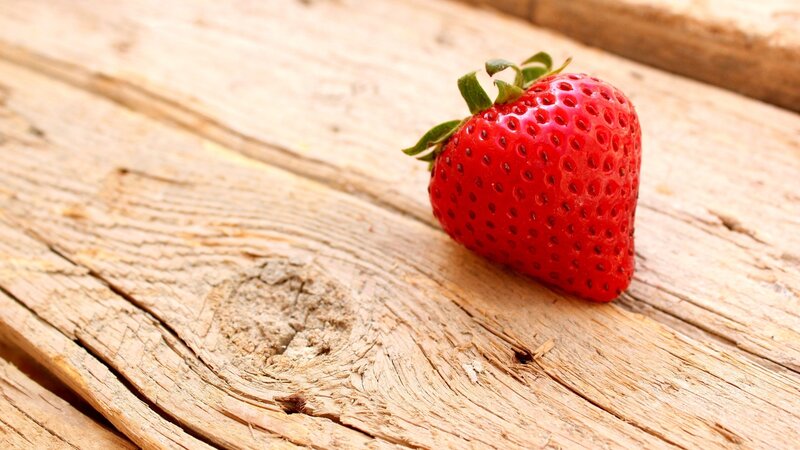 Single Strawberry on Wood