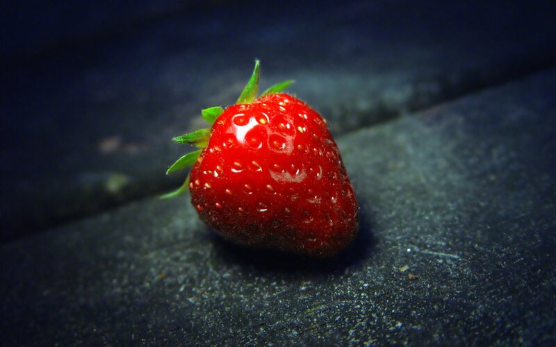 Single Strawberry — Red, Dramatic, Photograph, Green Leaves, Dark Surface, Black