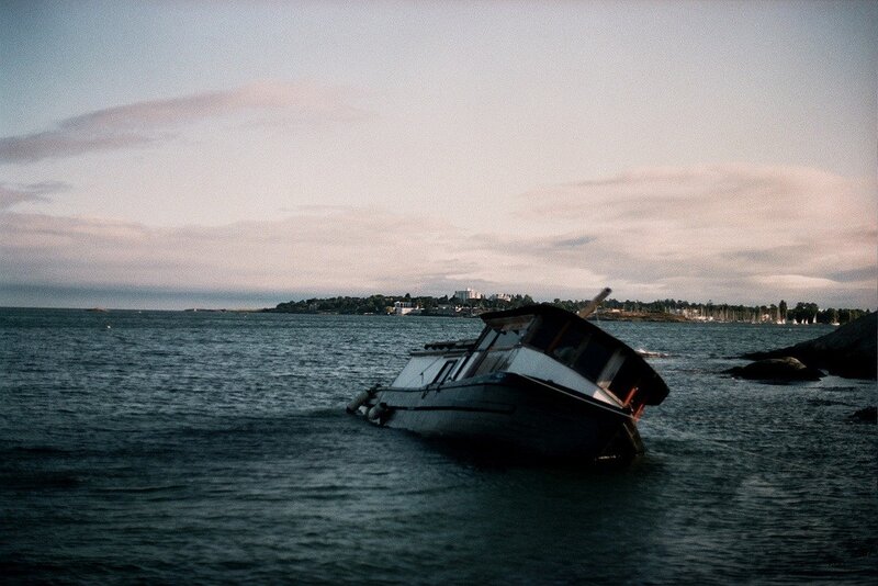 Sinking boat in coastal waters