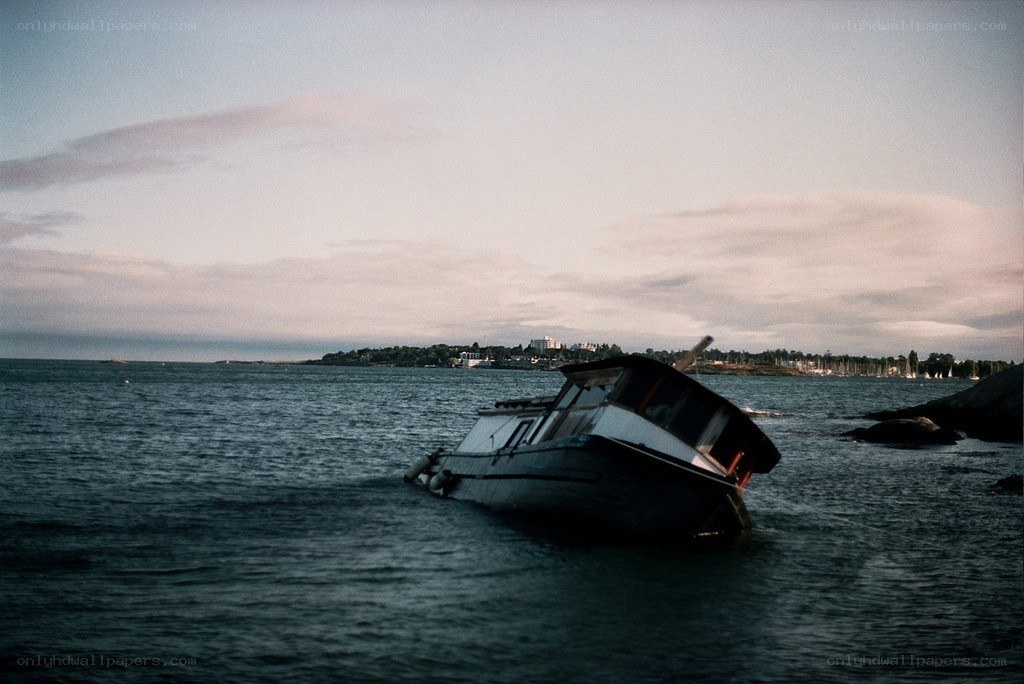 Sinking boat in coastal waters