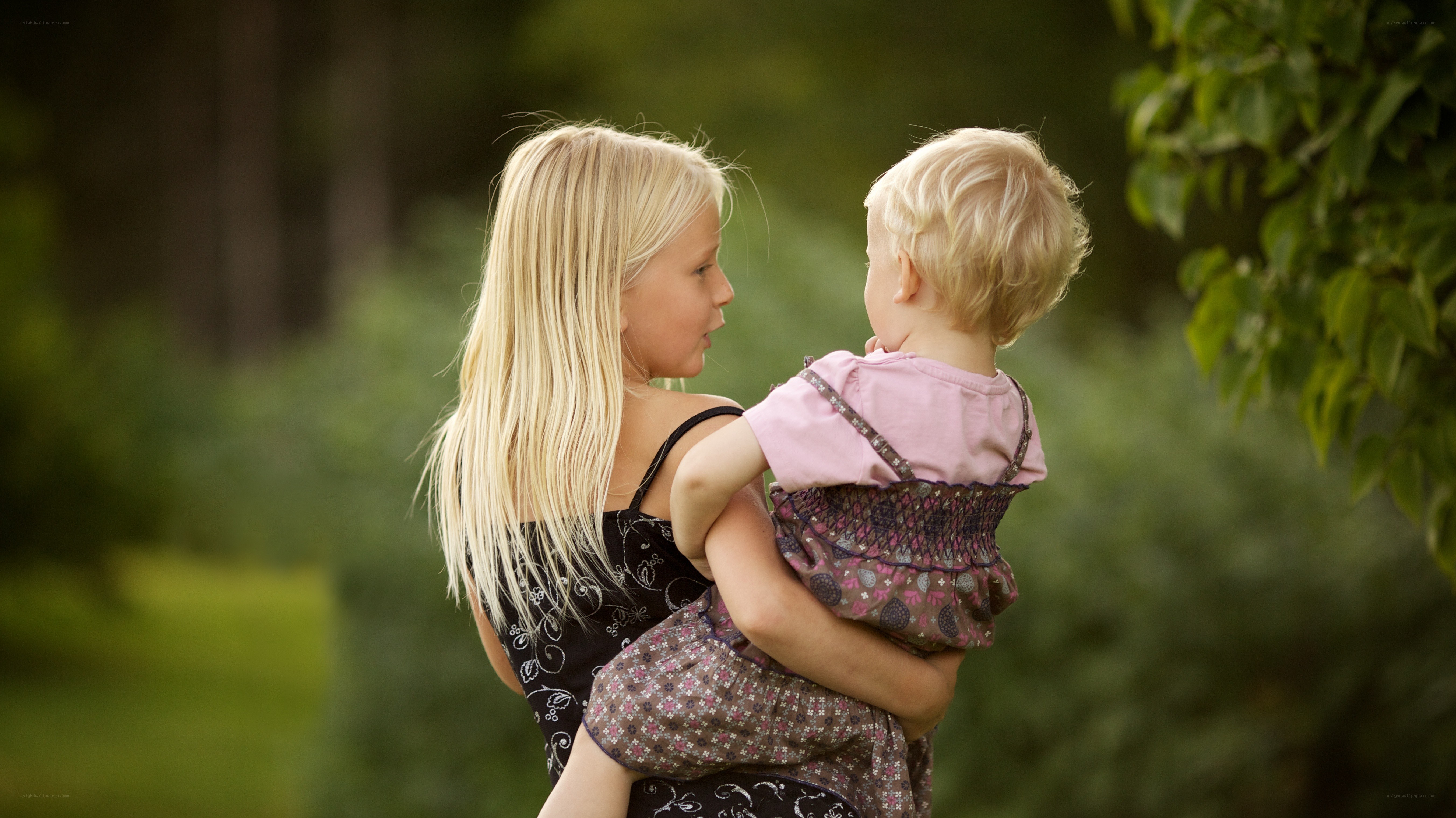 sister holding younger sibling
