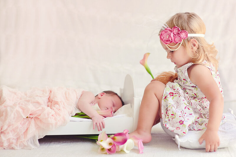 Sister Watching Newborn Baby