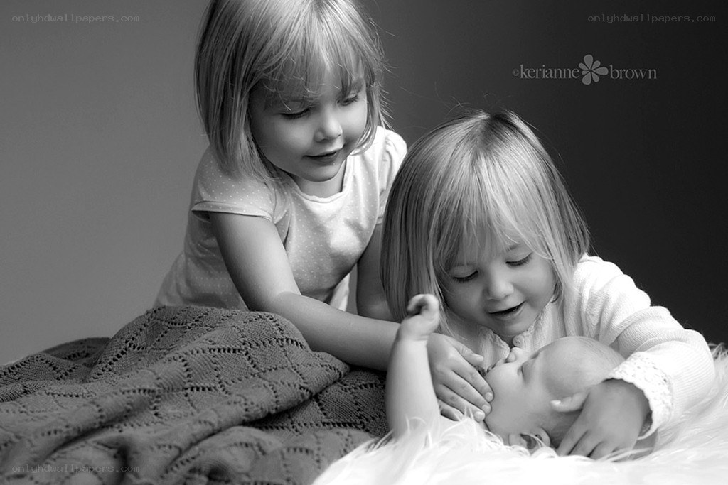 sisters with newborn baby