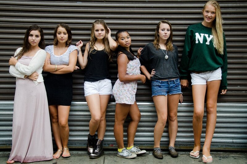 six girls standing in front of a shutter