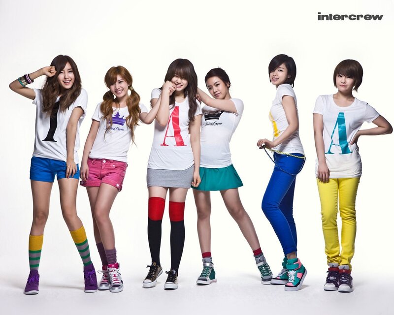 six women in colorful outfits