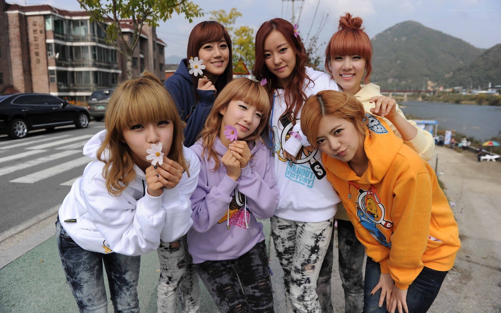 Six women posing with flowers