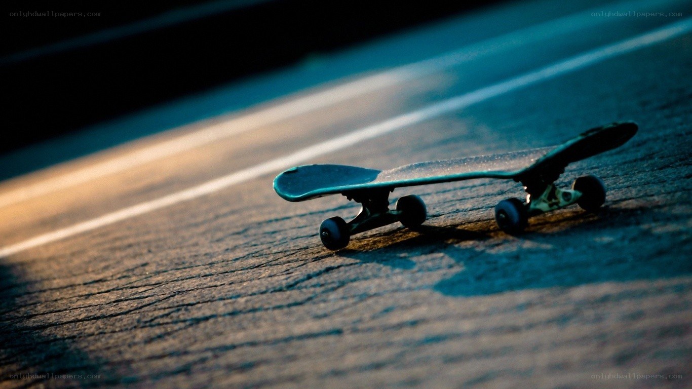 Skateboard on pavement at dusk