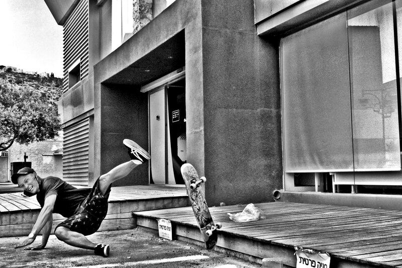 Skateboarder falls in front of building