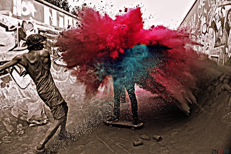 Skateboarder in colorful powder explosion