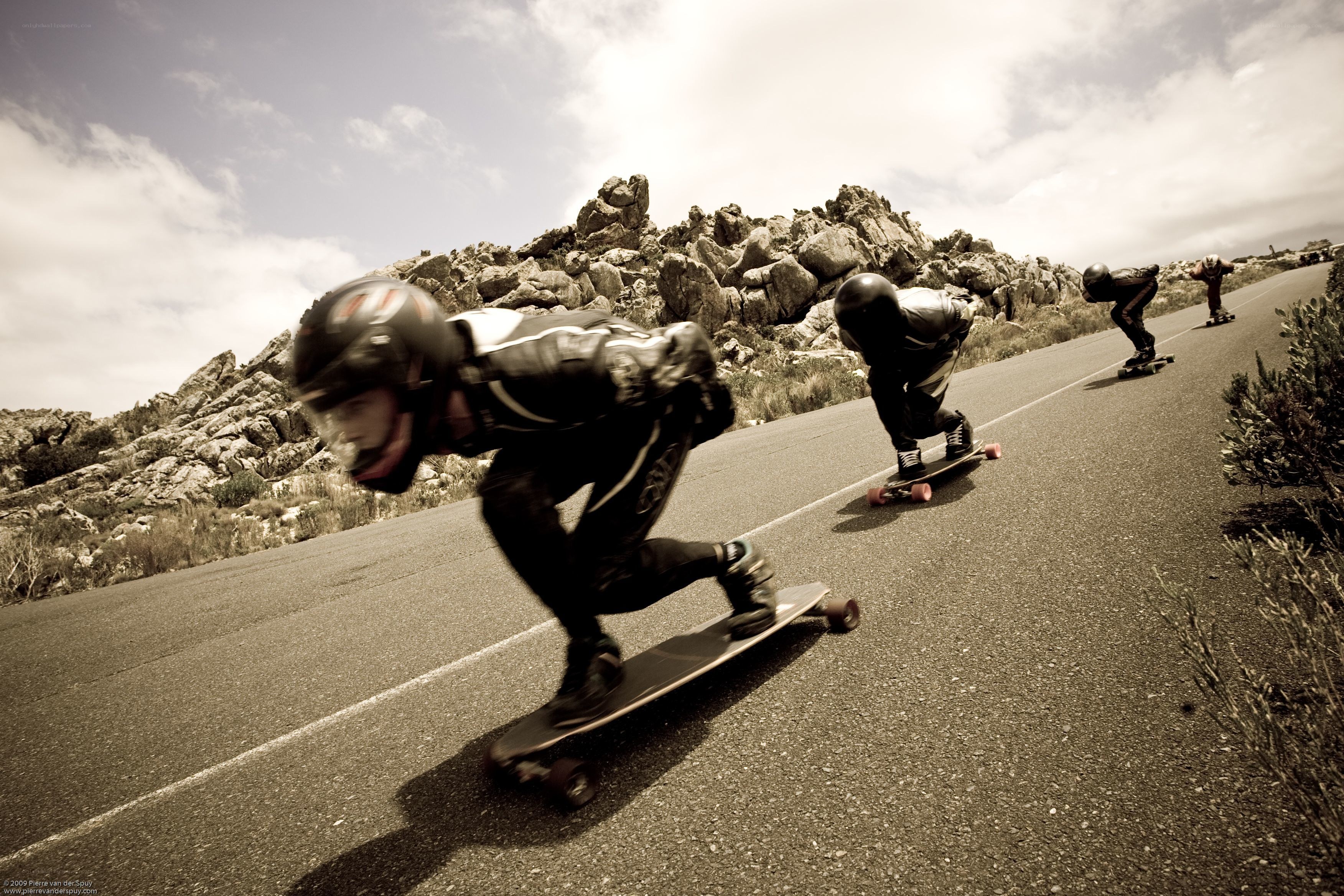 Skateboarders racing downhill