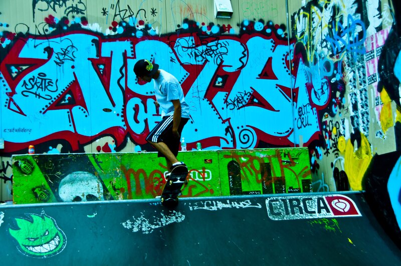 Skater at a graffiti-covered ramp