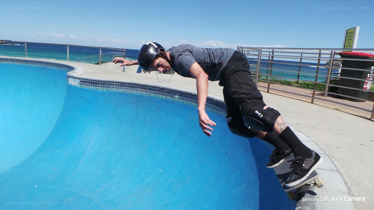 Skater at ocean-side pool