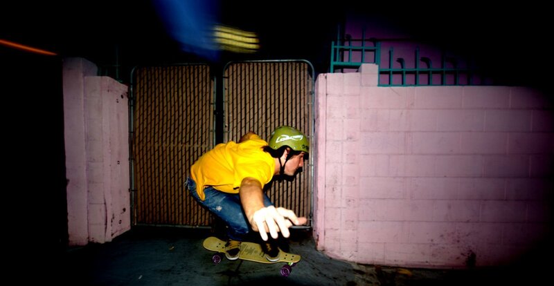 Skater in yellow shirt at night