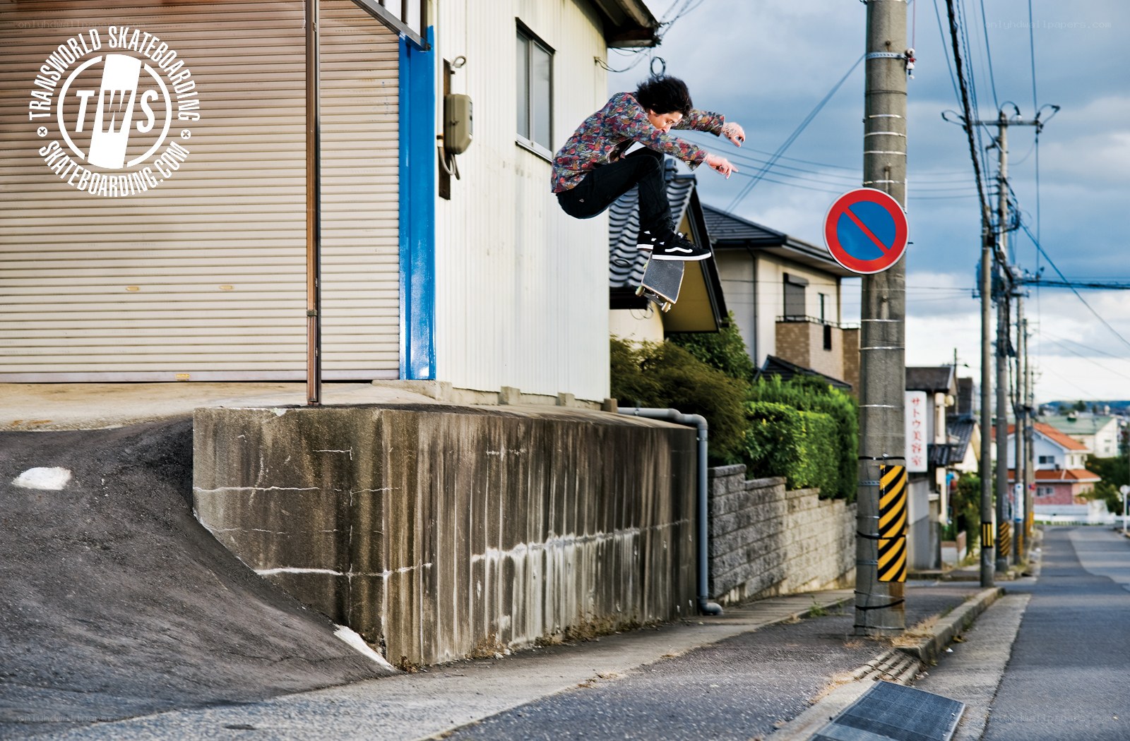 Skater jumps over ramp