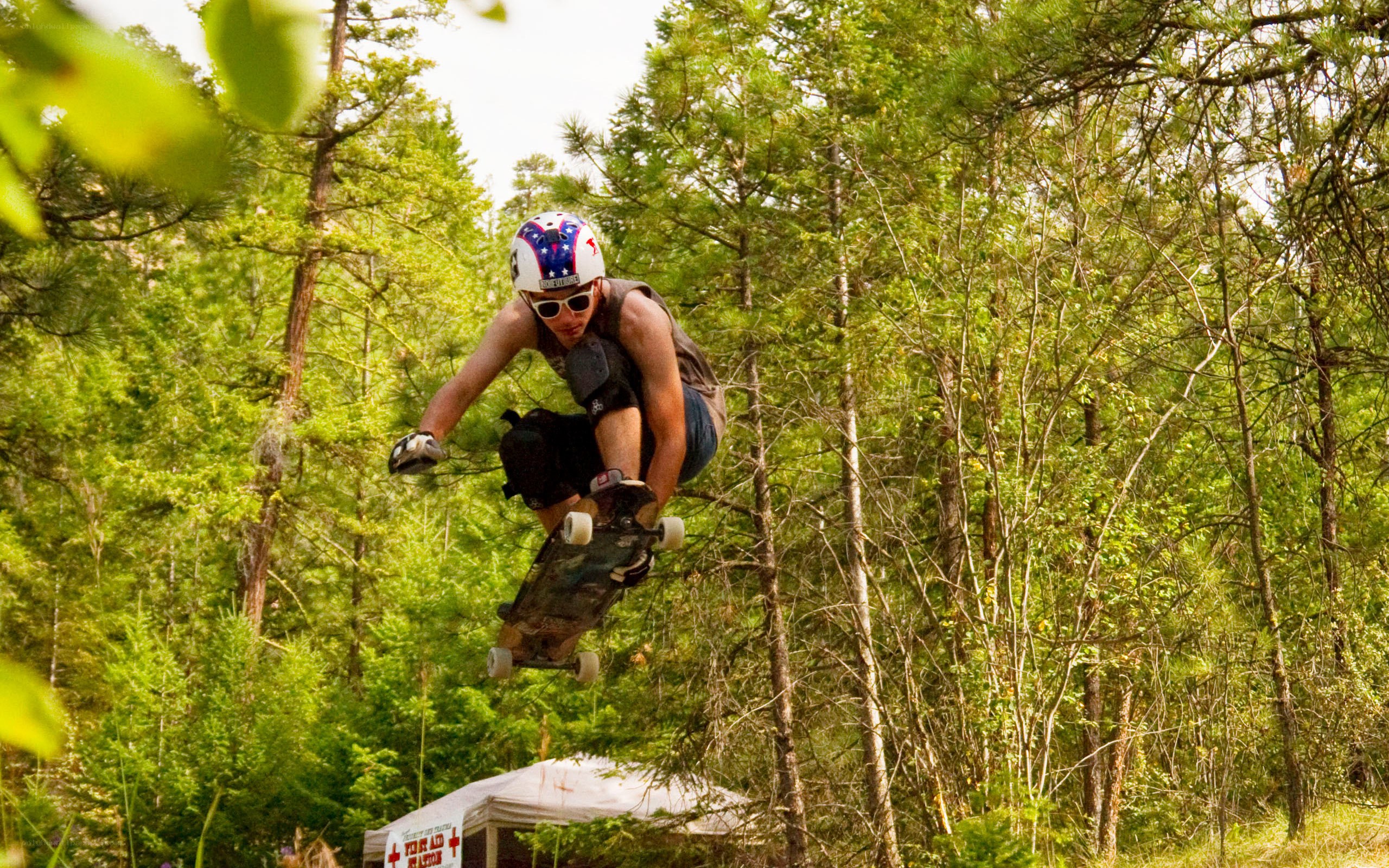 Skater mid-air in forest