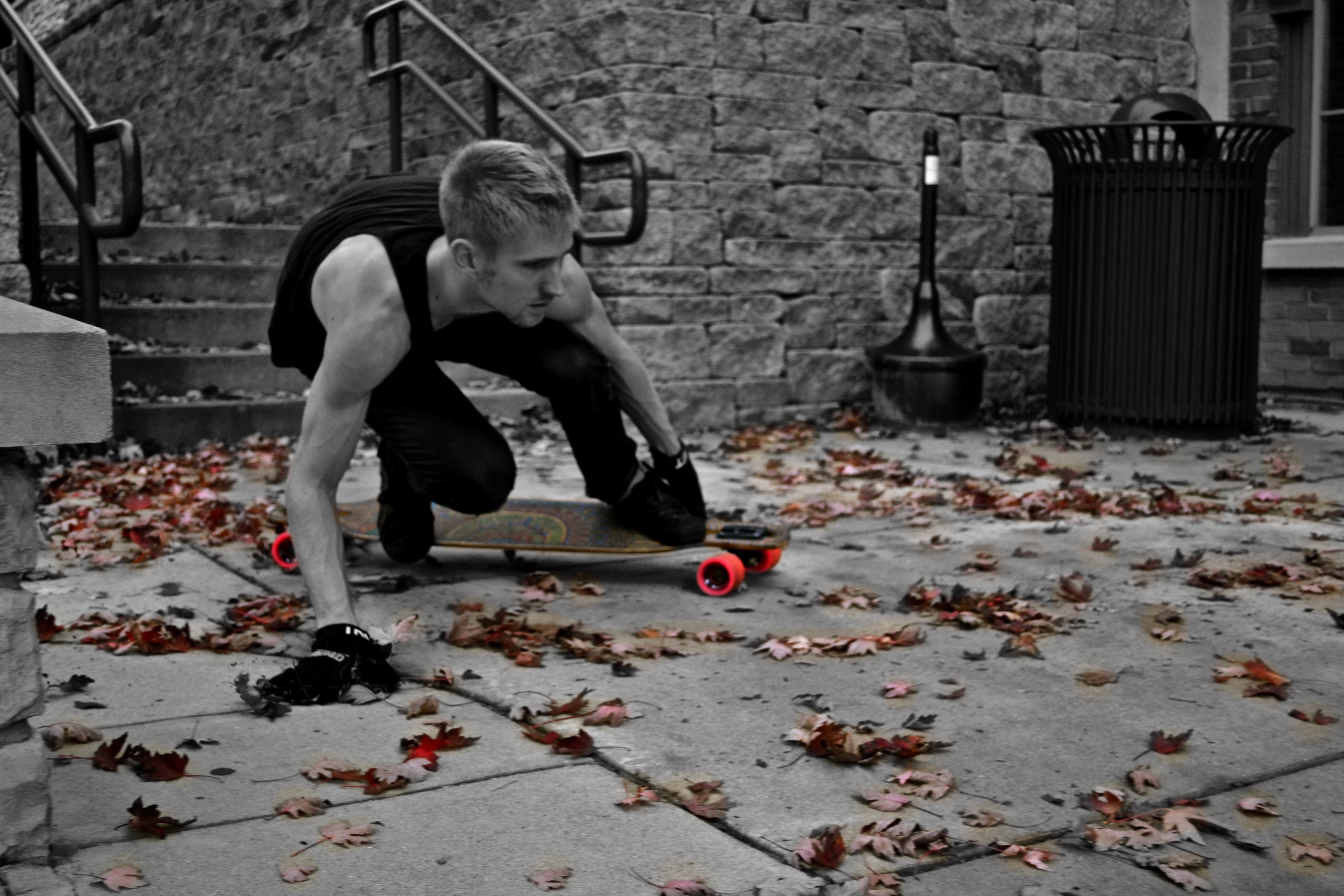 skater on a leaf-covered sidewalk