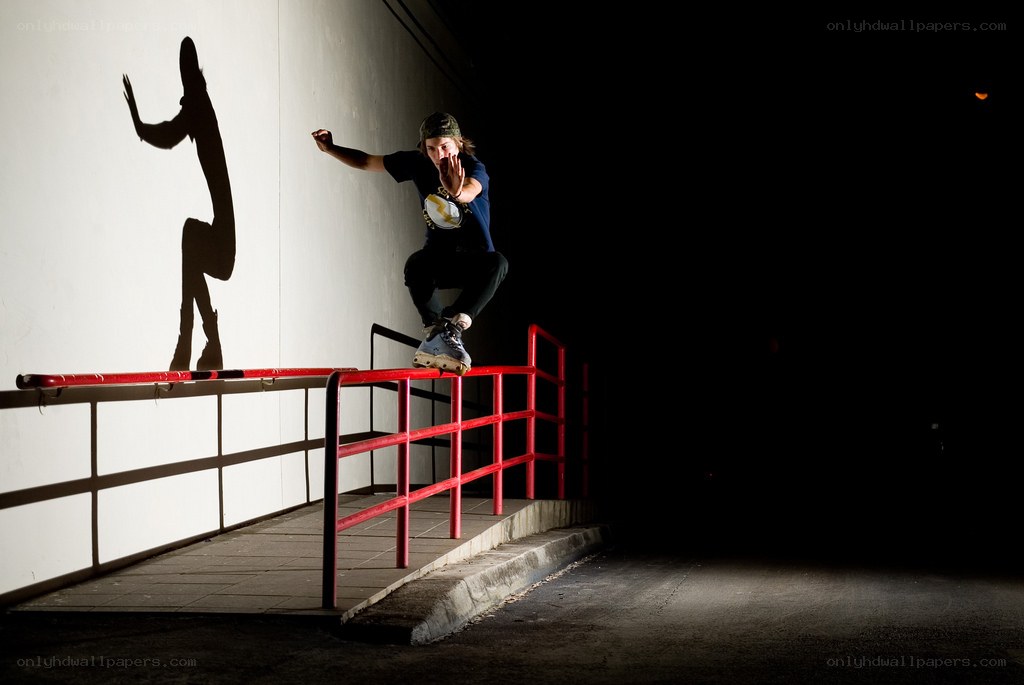 Skater on a rail at night