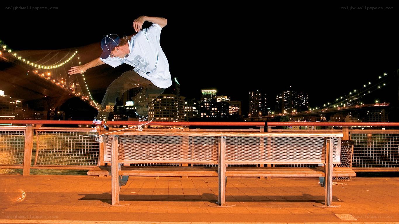 Skater on rail at night
