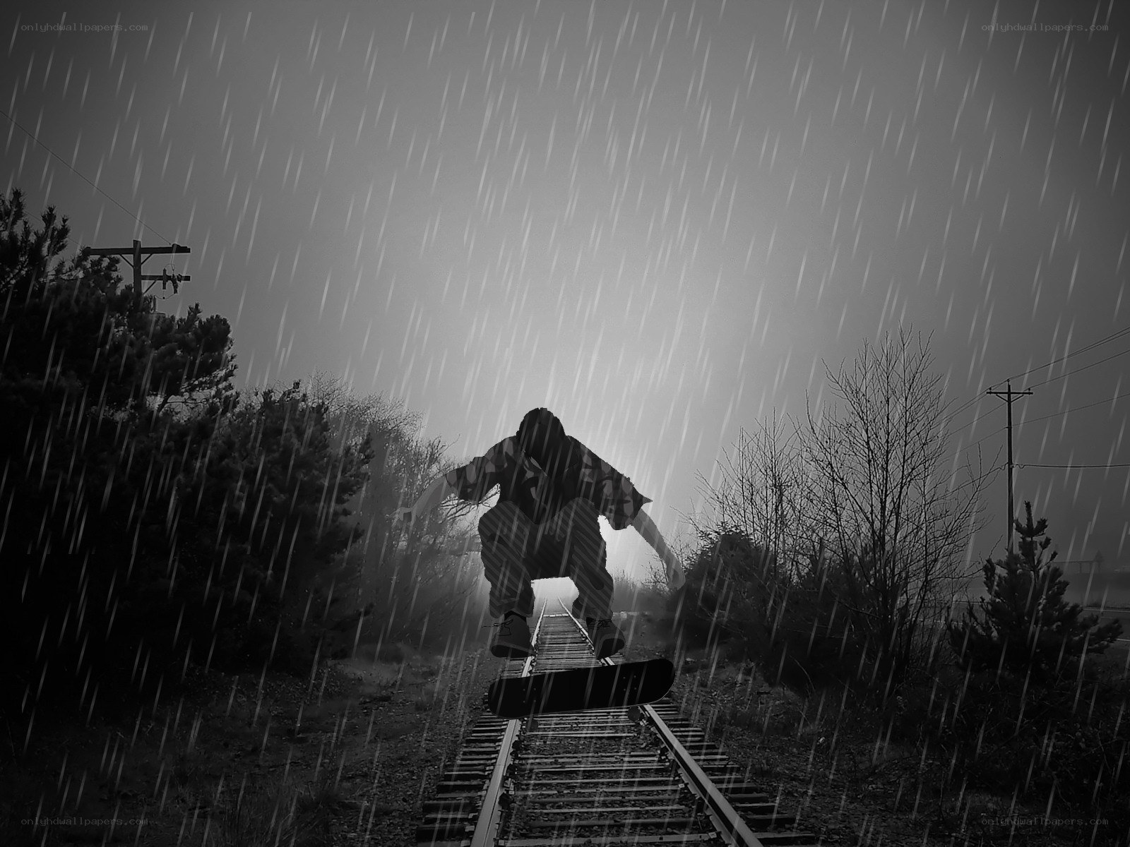 Skater on train tracks in rain