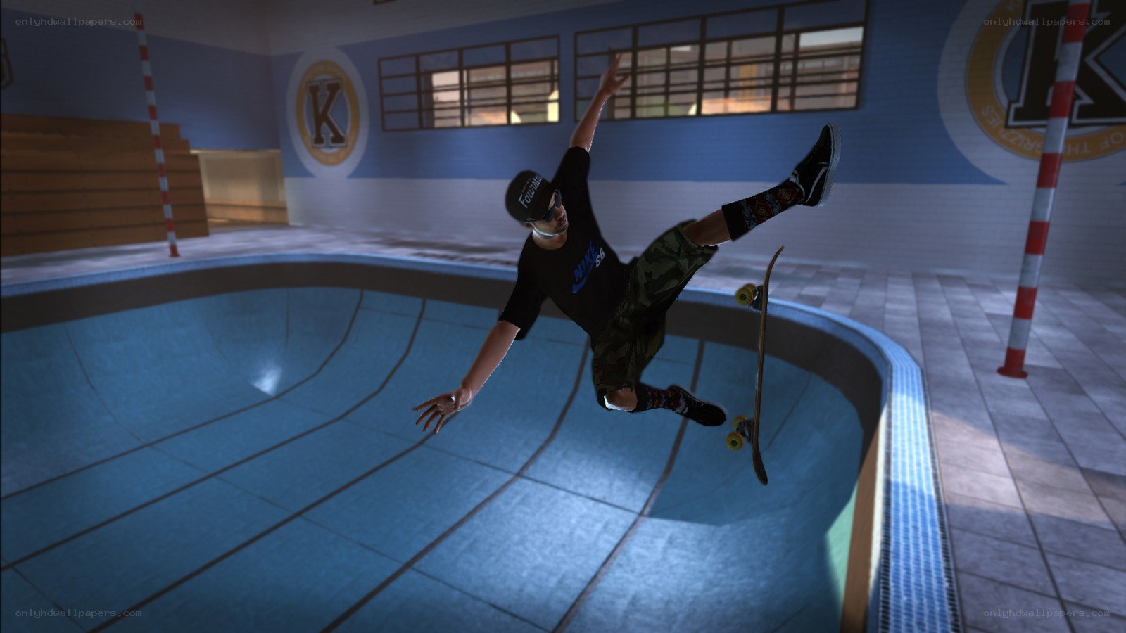 skater performing trick in bowl