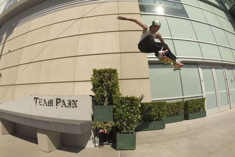 Skater performing trick in front of building