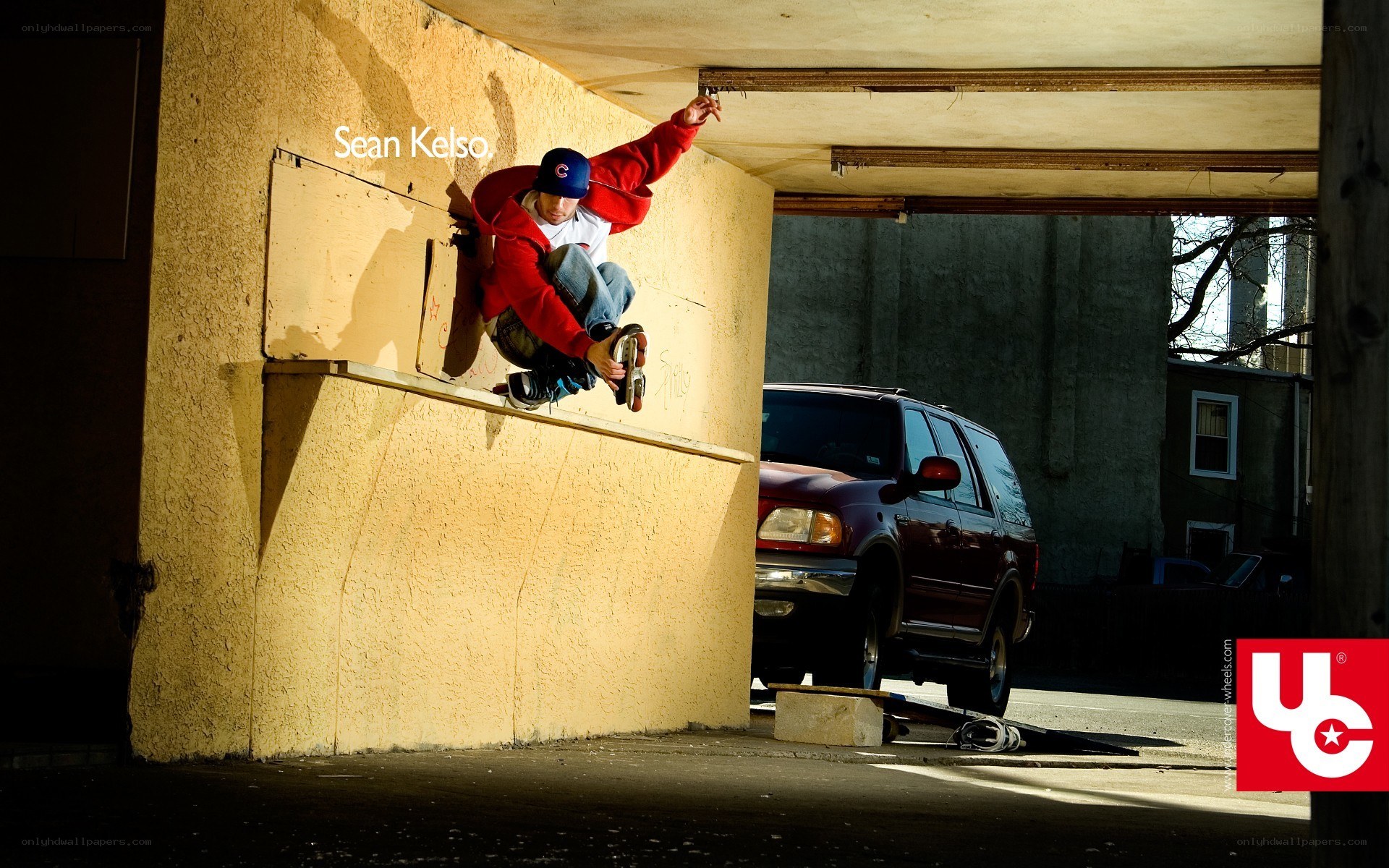 Skater performing trick under overpass