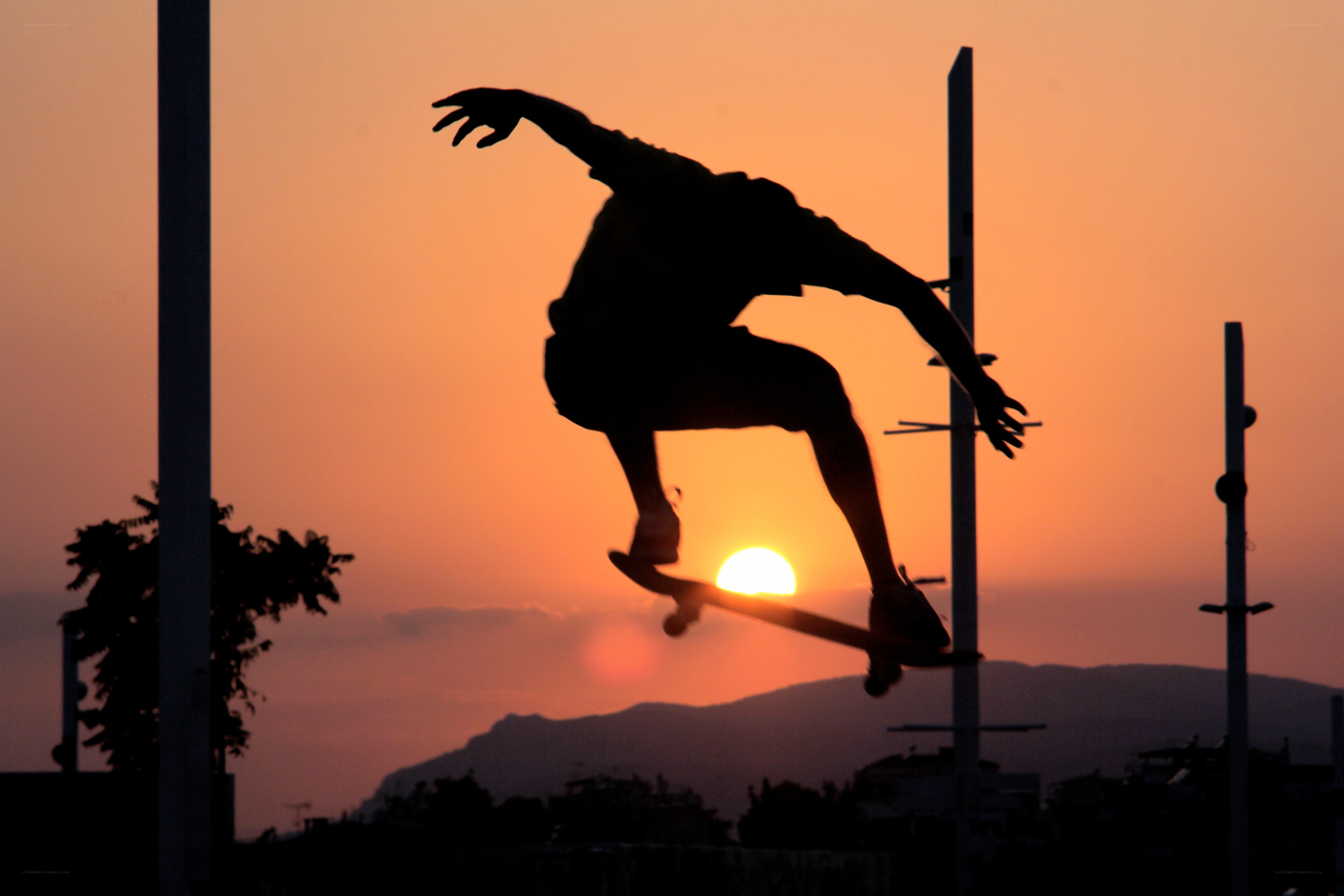 Skater silhouetted at sunset