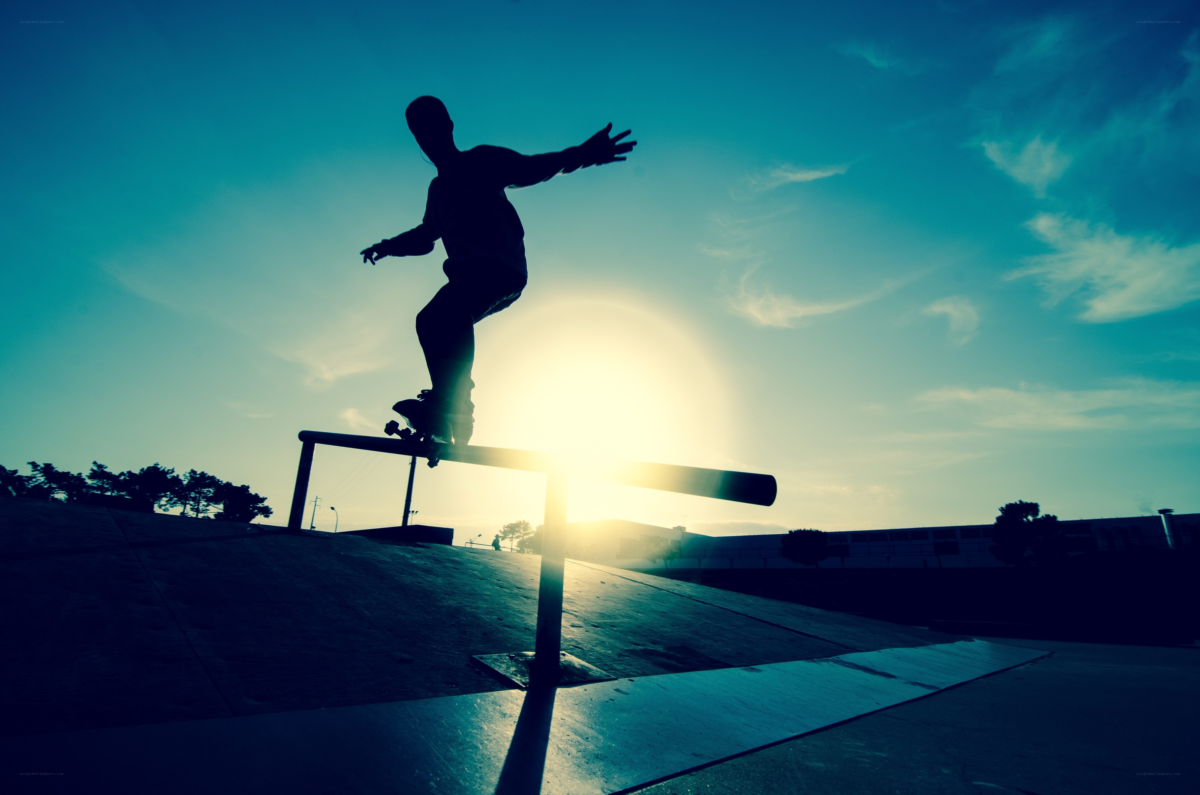 Skater silhouetted at sunset