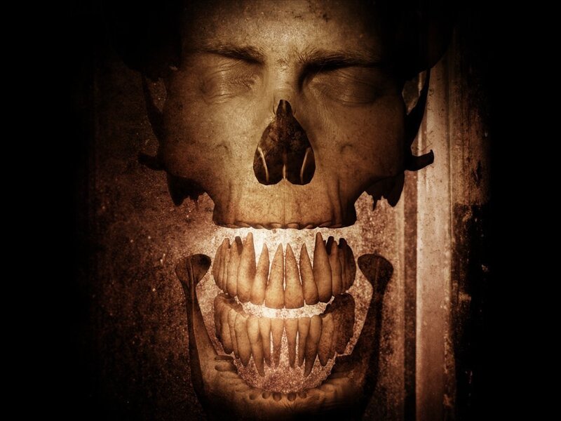 skeletal face with glowing teeth