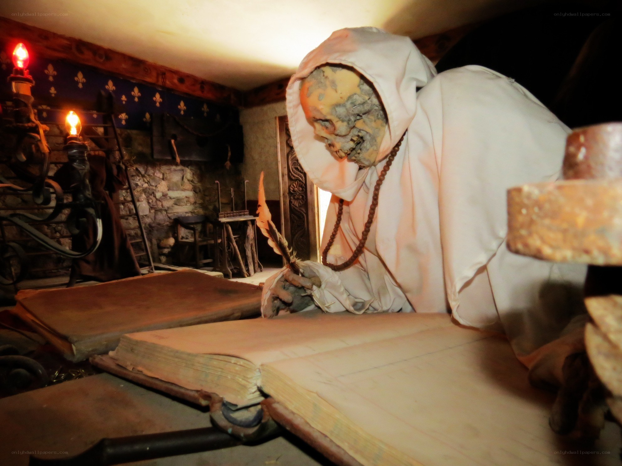 skeletal monk writing in a book