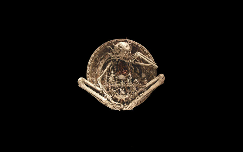 skeletal sculpture with miniature city
