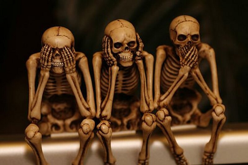 skeleton figurines in three poses