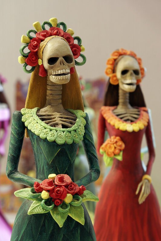 skeleton figurines with flowers