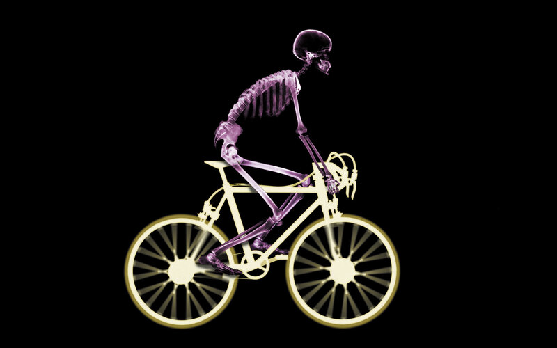 skeleton riding a bicycle