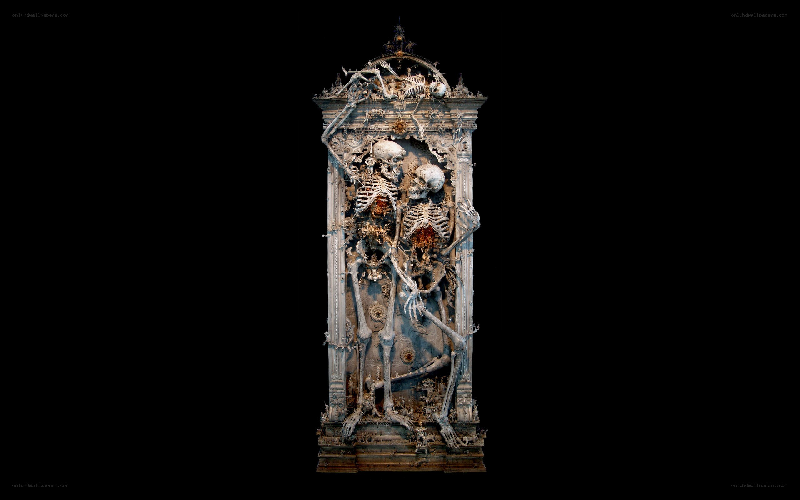 skeleton sculpture in ornate frame