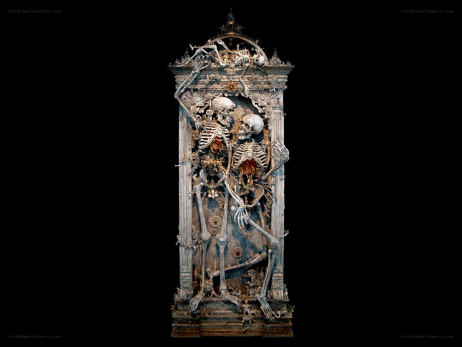 skeleton sculpture in ornate frame