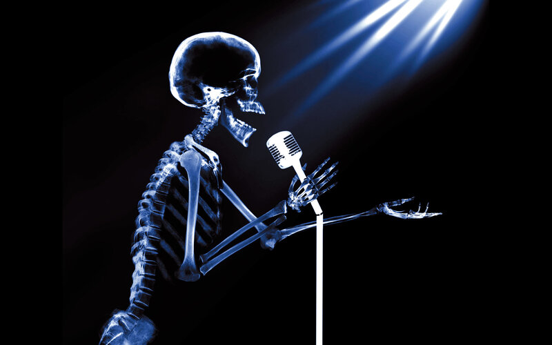 skeleton singing into microphone