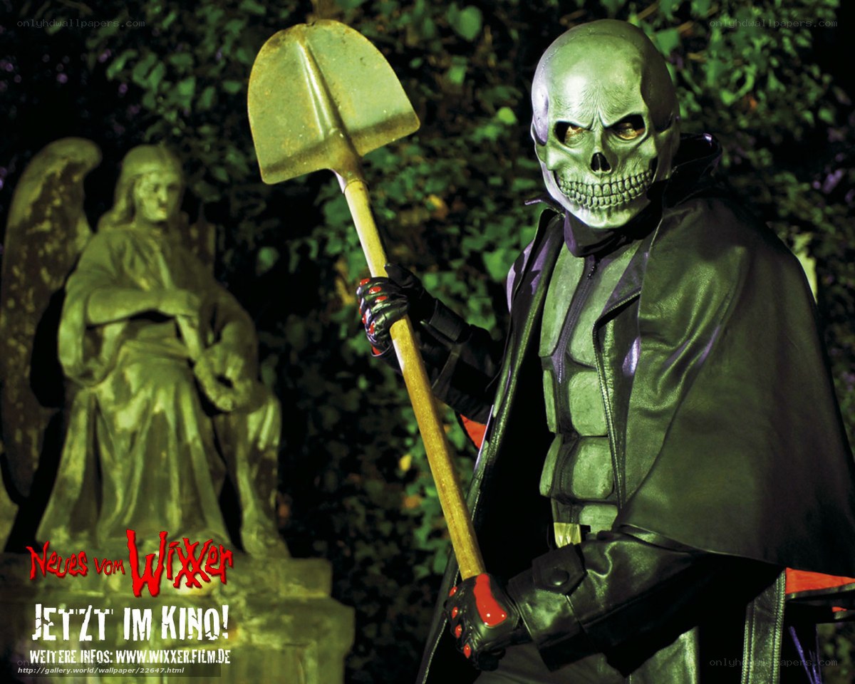 skeleton with shovel in cemetery