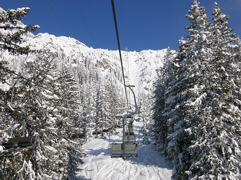 Ski Lift in Snowy Forest — White, Serene