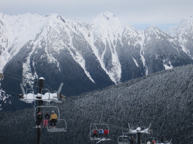 Ski lift with snowy mountains