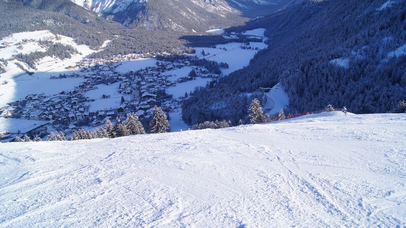 Ski slope overlooking a snowy village