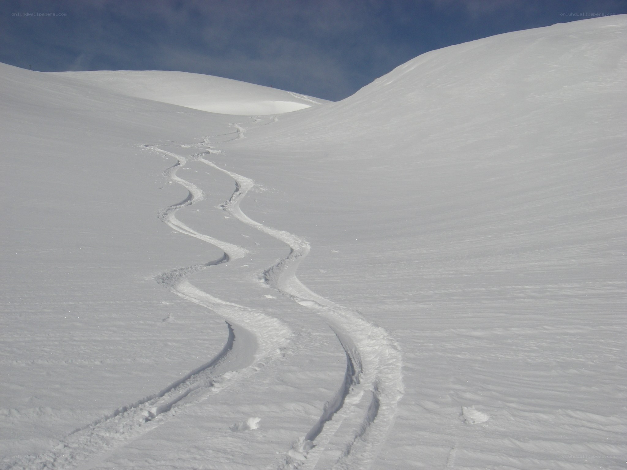 Ski tracks on a snowy slope