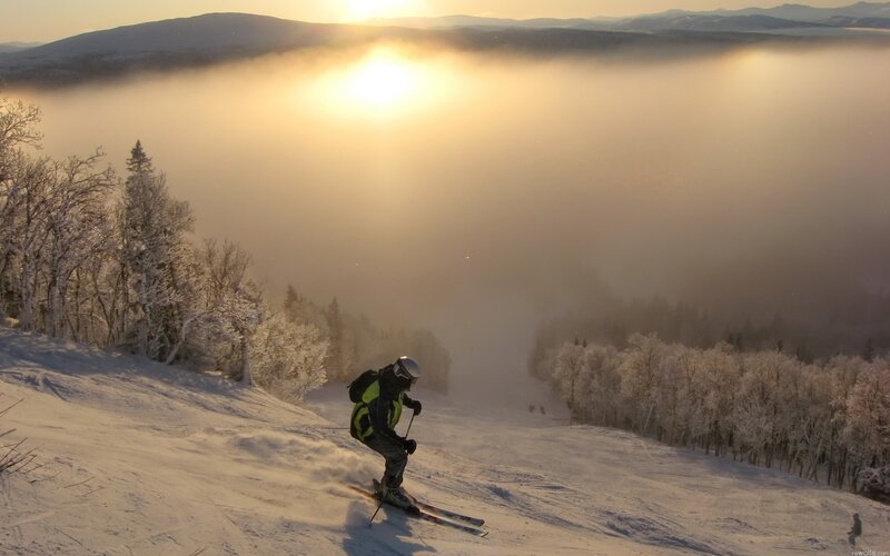 Skier at sunset in fog