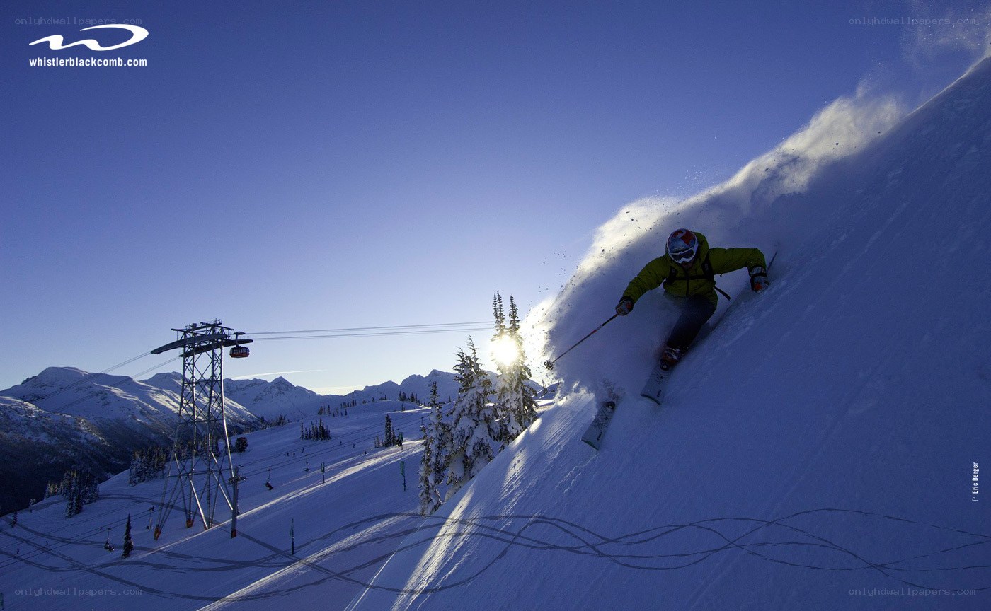 Skier carving down a snowy slope