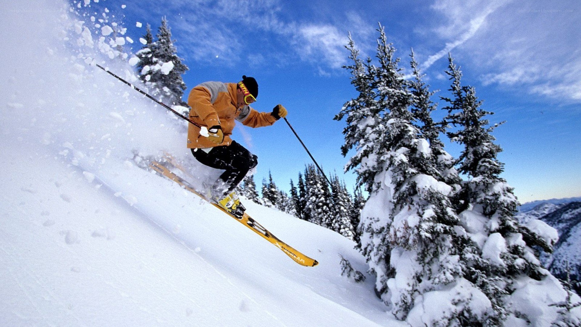 Skier carving down snowy slope
