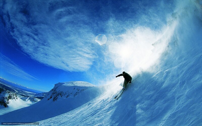 Skier carving down snowy slope