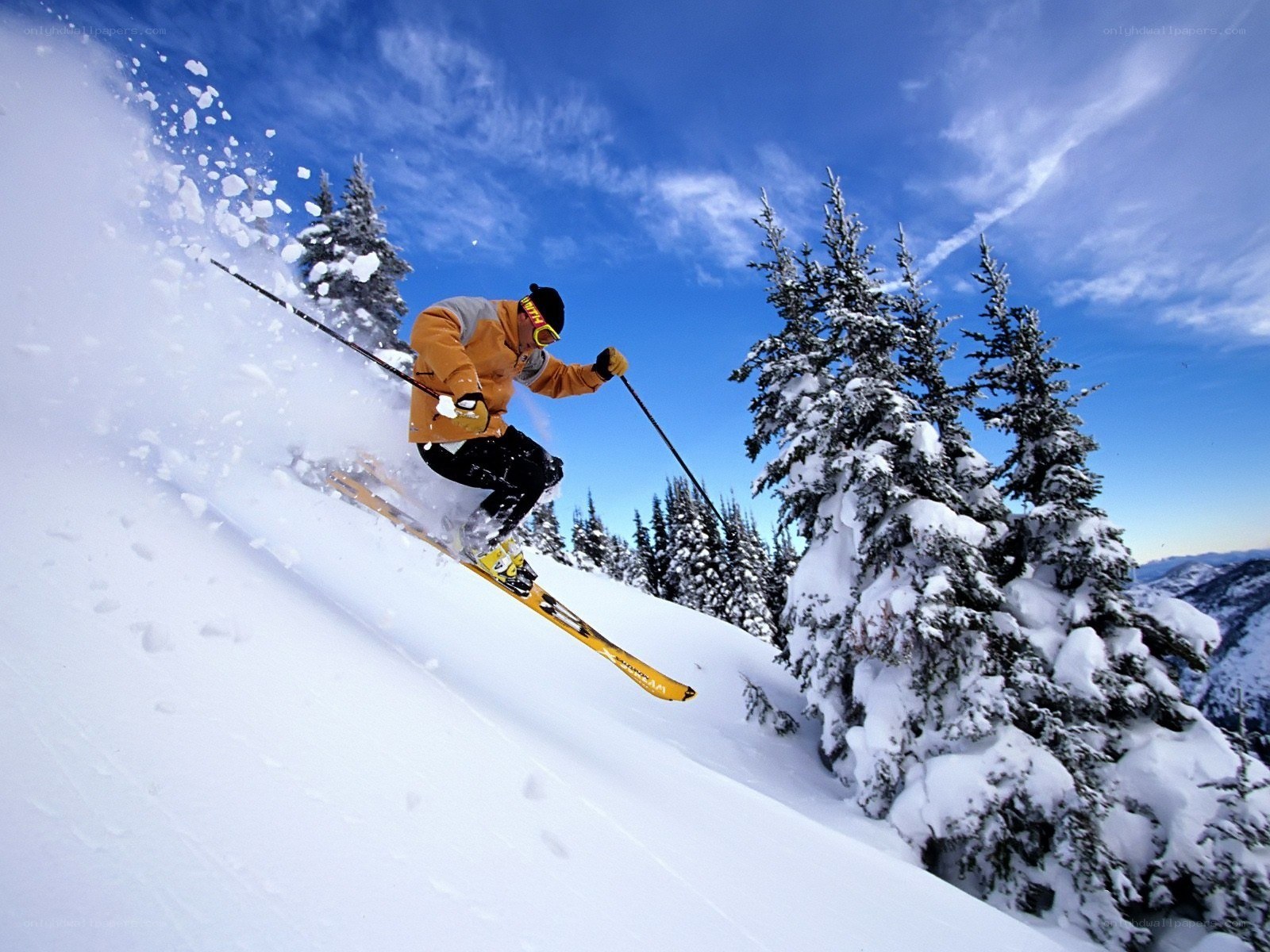 Skier carving down snowy slope